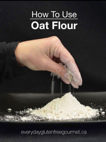A black background with a hand holding some oat flour from a pile below.