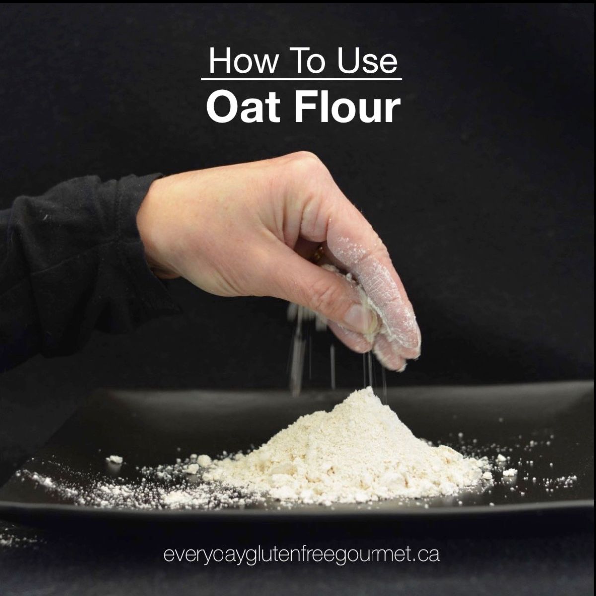 A black background with a hand holding some oat flour from a pile below.