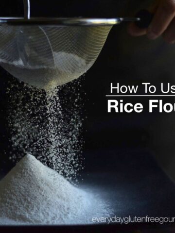A sifter with rice flour coming out of it onto a pile of flour below.