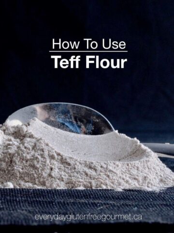 Black background with a pile of teff flour and a spoon behind it.