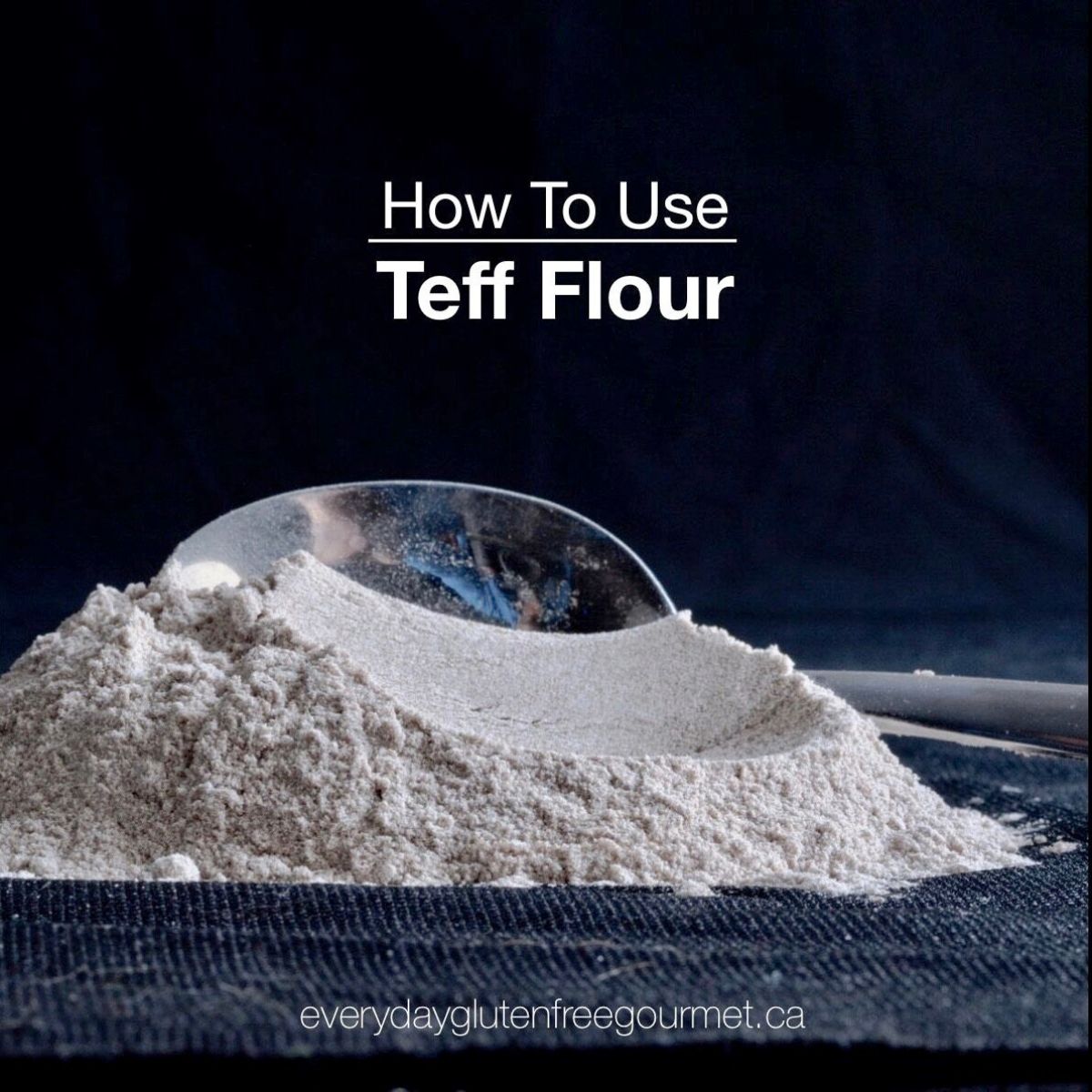 Black background with a pile of teff flour and a spoon behind it.