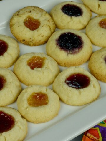 A tray of Jam Thumbprint Cookies with three different jams.