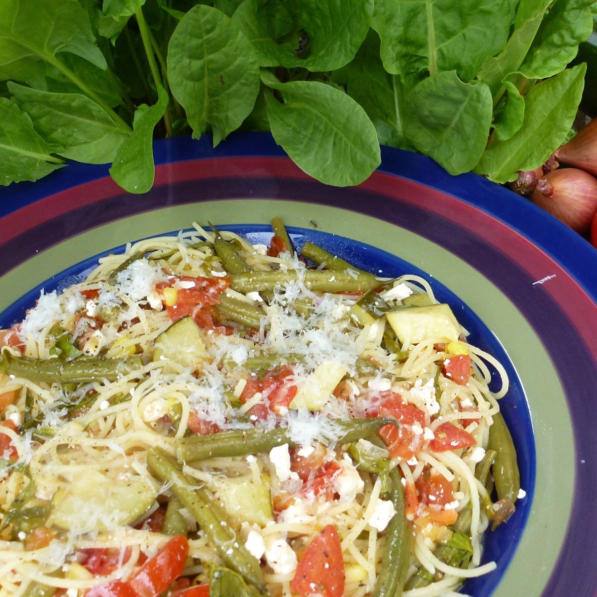 A bowl of pasta with fresh sorrel and feta.