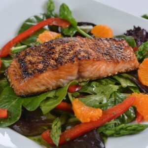 Sesame Salmon on Greens with red pepper, asparagus and orange segments.