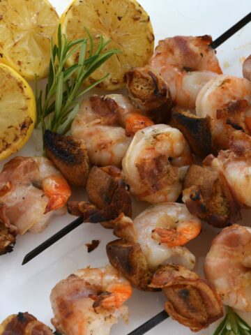 Skewers of Shrimp on the Barbie with pancetta and grilled lemons.
