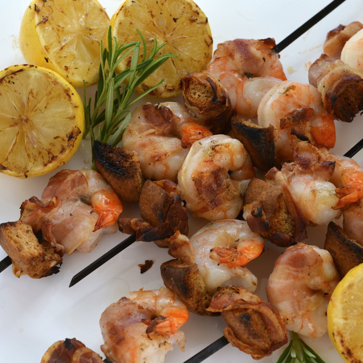 Skewers of Shrimp on the Barbie with pancetta and grilled lemons.