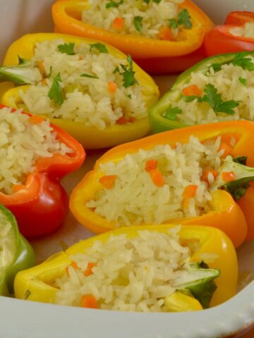 A baking dish of colourful Stuffed Peppers filled with rice.