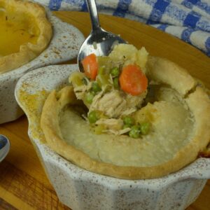 A spoon dug into a Turkey Pot Pie showing the creamy filling.