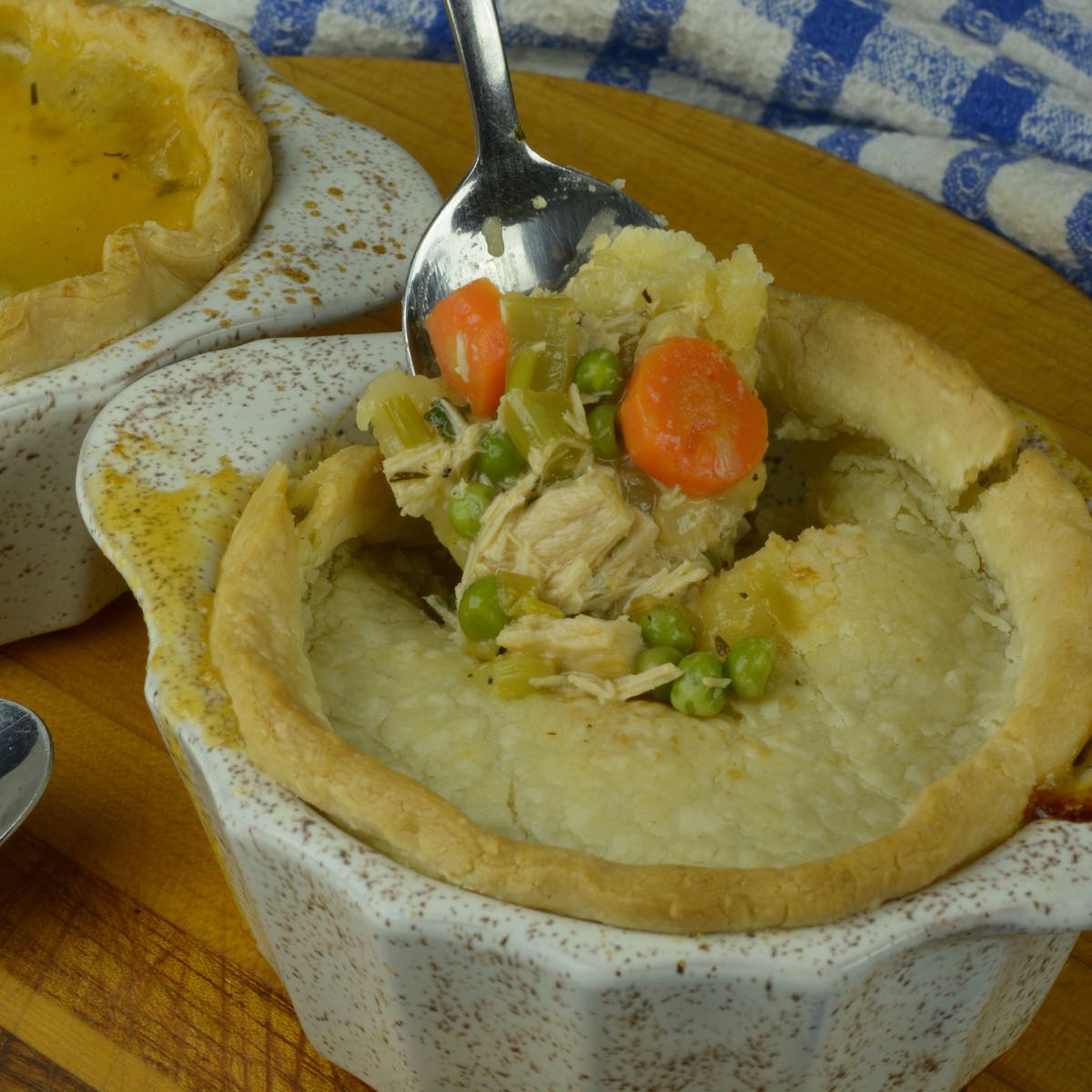 A spoon digging into the creamy filling of a Turkey Pot Pie.