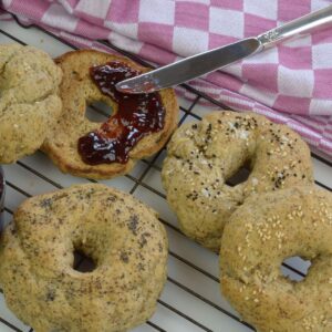 Vegan Bagels just out of the oven served with strawberry jam.