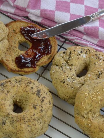 Vegan Bagels just out of the oven served with strawberry jam.