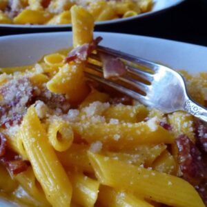 A dish of gluten free macaroni and cheese made with sharp cheddar and bacon.