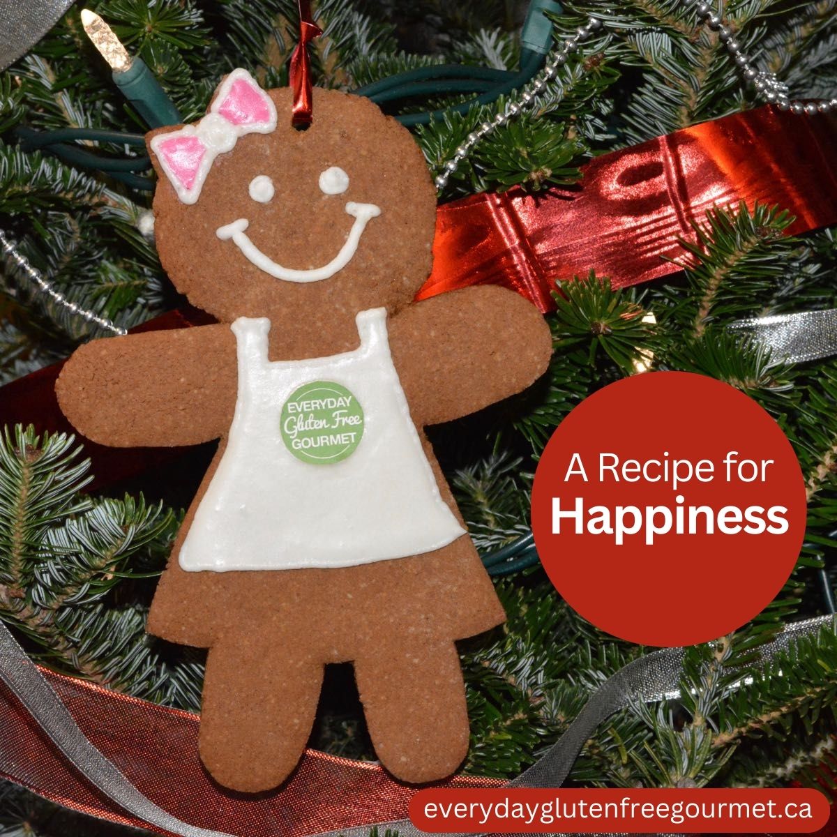 A gingerbread lady wearing a white apron with the Everyday Gluten Free Gourmet logo, hanging on a Christmas tree.