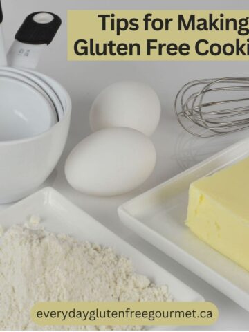 Measuring cups, a whisk, eggs, butter and gluten free flour.