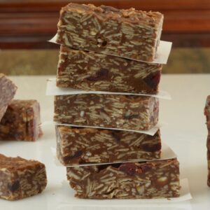 A close up of Chocolate Coconut Oat Bars showing the strands of coconut and the dried fruit inside.