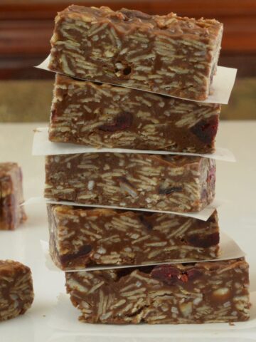 A close up of Chocolate Coconut Oat Bars showing the strands of coconut and the dried fruit inside.