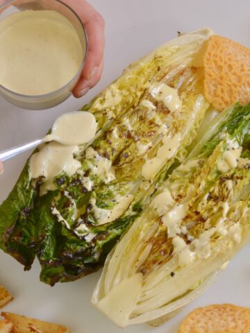 Grilled Romaine Hearts Caesar Salad with gluten free croutons and Parmesan cheese wafers