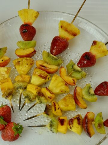 A platter of Grilled Fruit Skewers with Honey Cinnamon Glaze.