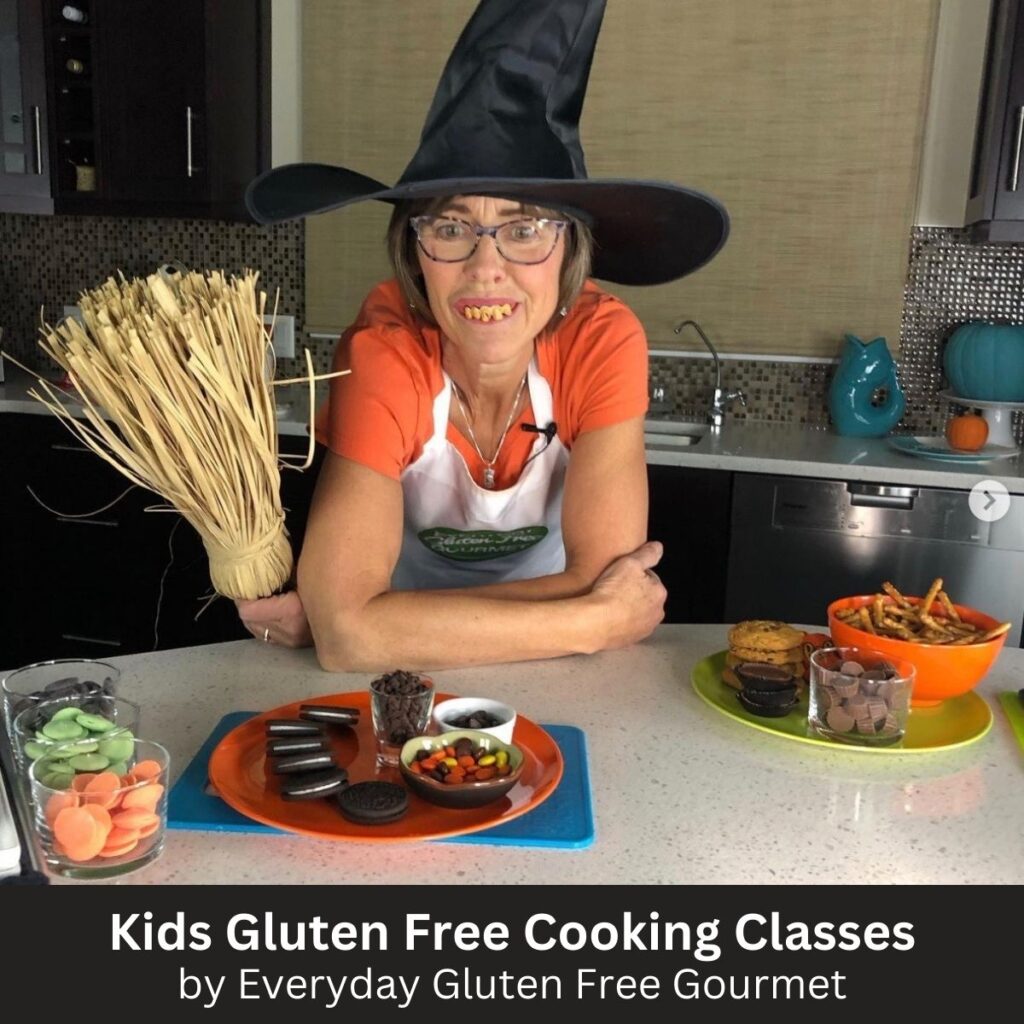 Cinde in an orange t-shirt, witch hat and rotten teeth during a virtual kids cooking class. 