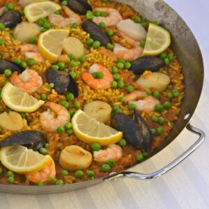 A paella pan filled with Paella with Seafood