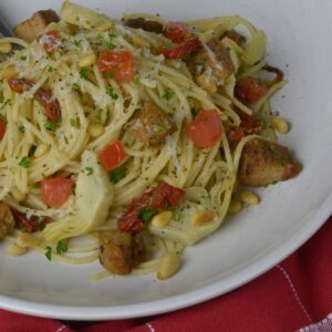 A bowl of gluten free pasta tossed with Sausage and Vegetables.