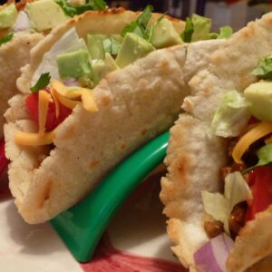 Gluten free turkey tacos made with homemade corn tortillas lined up in taco holders.