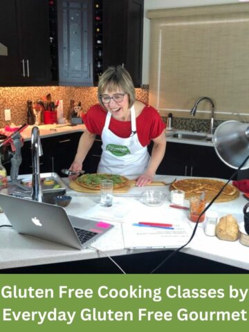 Cinde in her kitchen set up for a virtual cooking class with lights, camera, laptop and pizza that just came out of the oven.