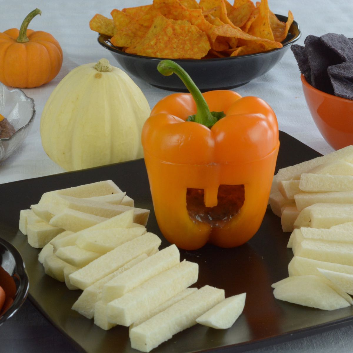 Black Bean Dip served in an orange pepper cut to look like a jack-o'-lantern.