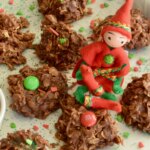 Gluten free Uncooked Dainties covered with red and green holiday sprinkles and a little felt elf.