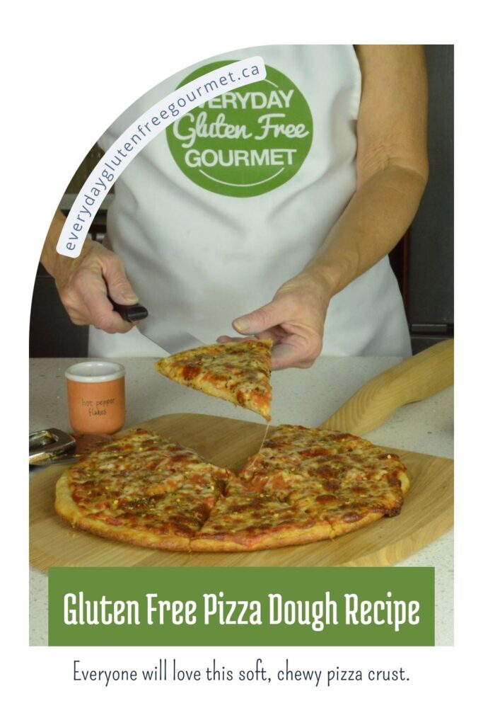 Cinde serving a piece of gluten free pizza off the wooden pizza peel.