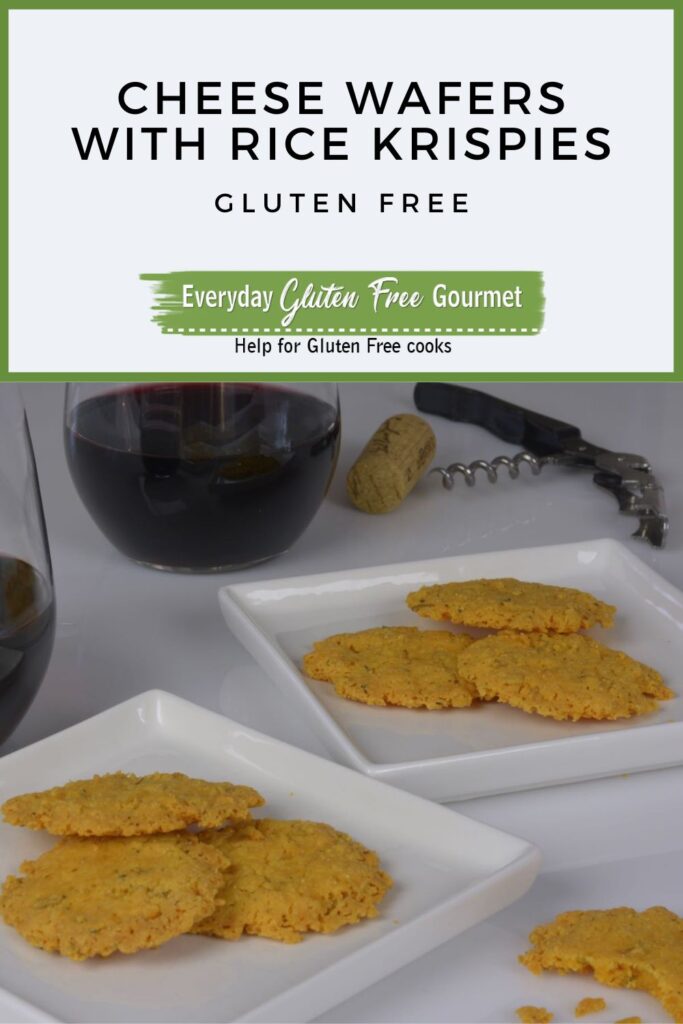 Two plates of Cheese Wafers with Rice Krispies beside glasses of red wine.