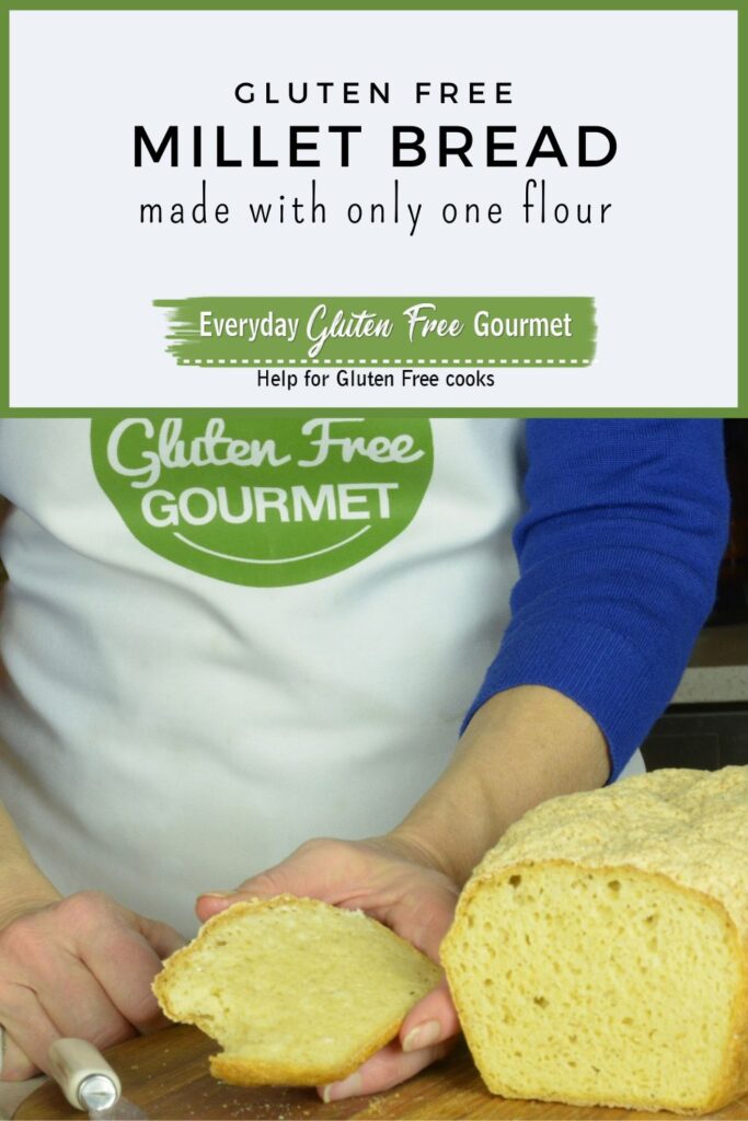 Someone holding a warm slice of gluten free millet bread, beside the whole loaf it was cut from, covered with butter.