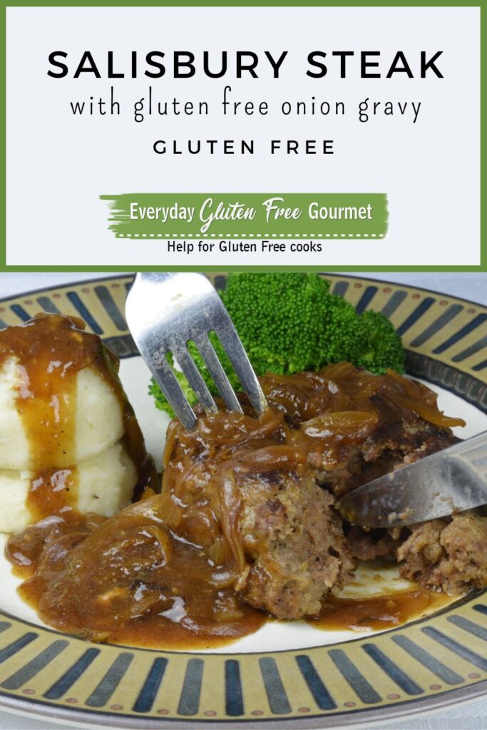A plate with a fork and knife cutting into a Salisbury Steak smothered in gluten free onion gravy, surrounded by mashed potatoes and broccoli.