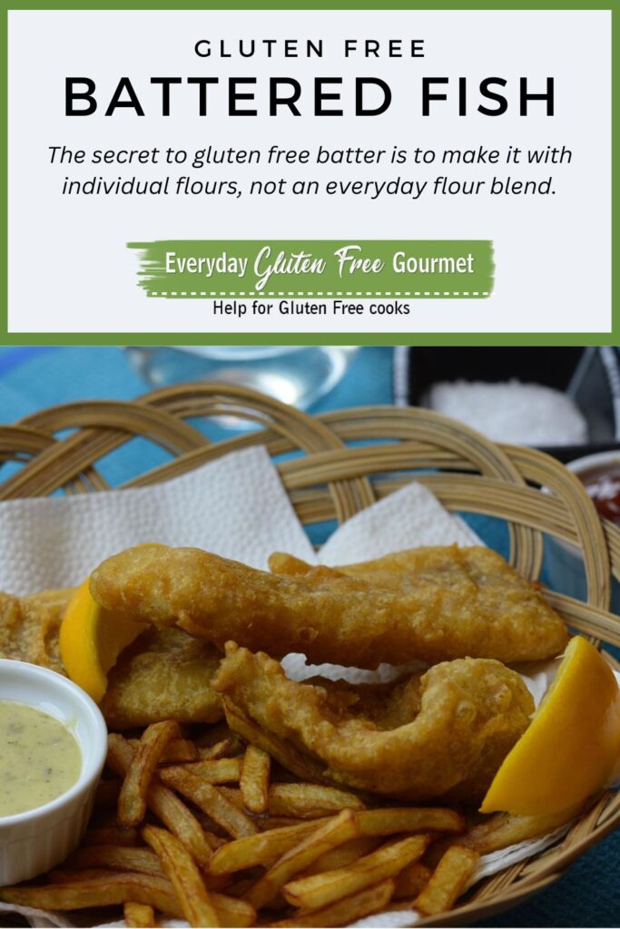 A basket of gluten free battered fish with fries, a dish of tartar sauce and a few lemon wedges.