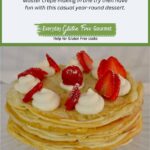 A gluten free Crepe Cake Filled with Pastry Cream decorated with whipped cream and fresh strawberries.