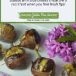 Grilled Figs Stuffed with Blue Cheese and wrapped with prosciutto on a white platter surrounded by pink flowers.