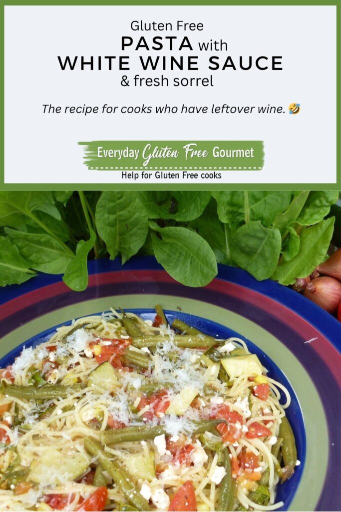 A bowl of gluten free pasta with white wine sauce, sorrel, green beans, zucchini, tomatoes and feta cheese.