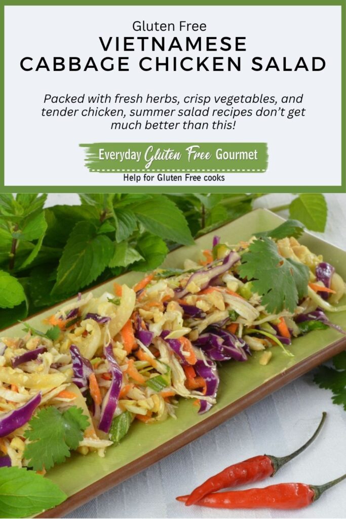 A plate with Vietnamese Cabbage Chicken Salad garnished with peanuts, mint, cilantro and fresh lime.