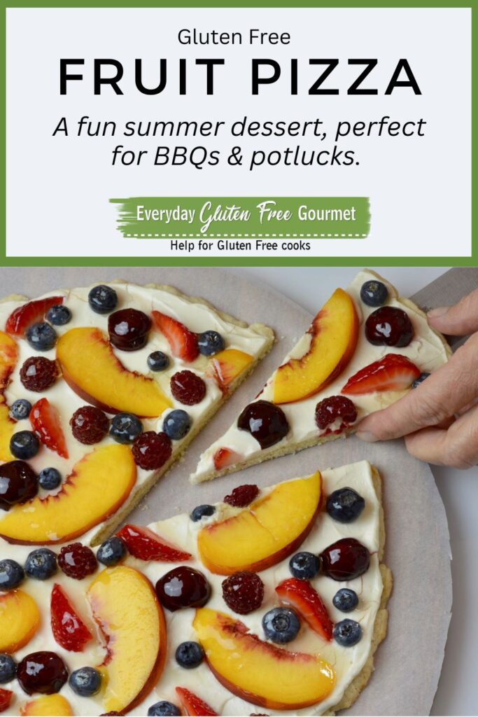 A cut piece of a gluten free Fresh Fruit Pizza being lifted off a serving tray.