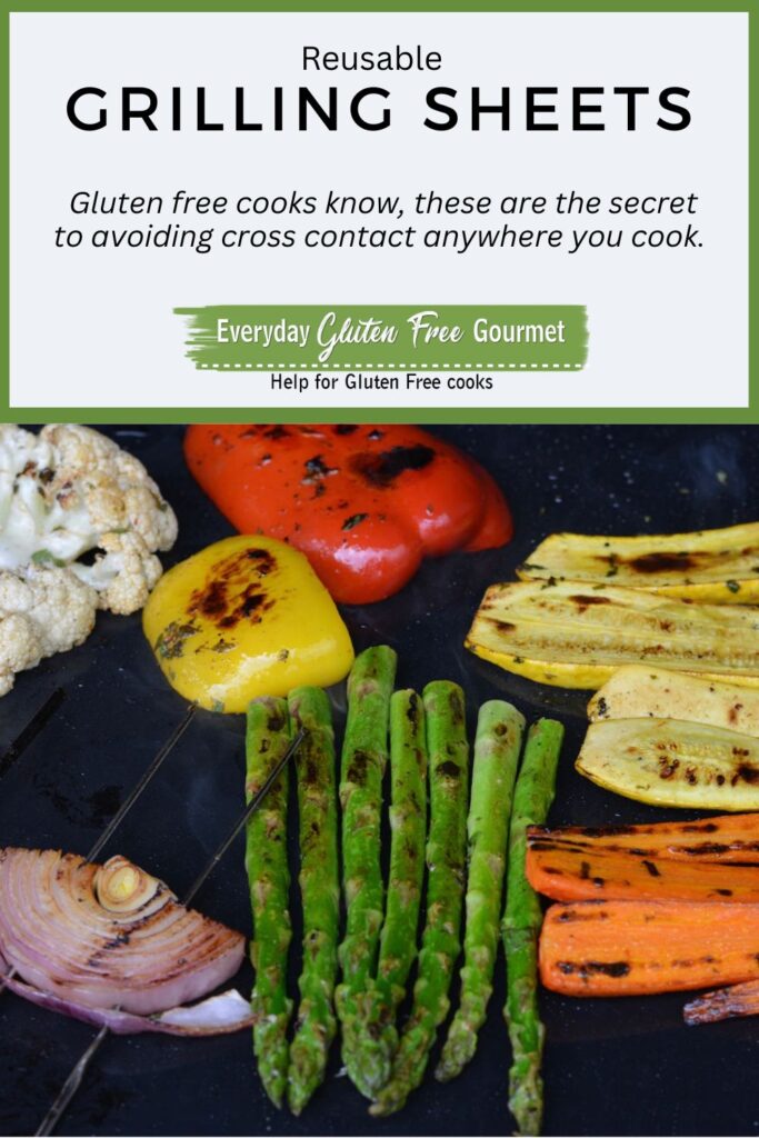 A reusable grilling sheet on the barbecue covered with cooked vegetables that all show nice grill marks.