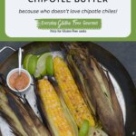 A pan of Grilled Corn on the cob with lime wedges and a dish of chipotle butter.