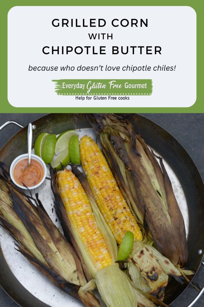 A pan of Grilled Corn on the cob with lime wedges and a dish of chipotle butter.