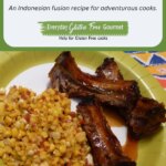 Cut up pieces of Sweet Chili Root Beer Ribs glazed with sauce on a plate with cooked corn.