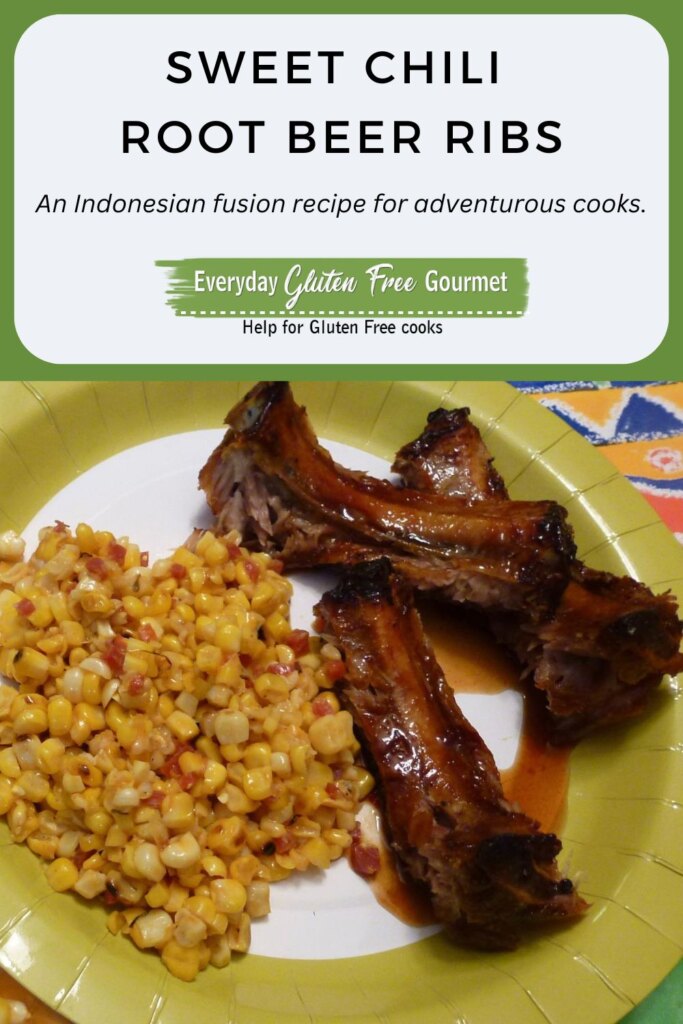 Cut up pieces of Sweet Chili Root Beer Ribs glazed with sauce on a plate with cooked corn.