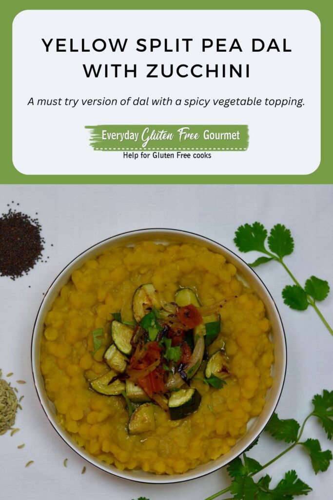 A bowl of Yellow Split Pea Dal topped with sauteed zucchini, tomato and spices.