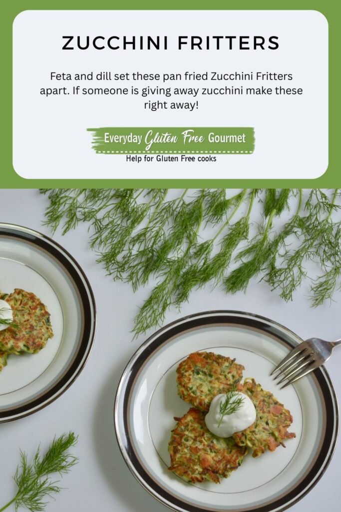 Two plates of gluten free Pan Fried Zucchini Fritters topped with sour cream and garnished with fresh dill.