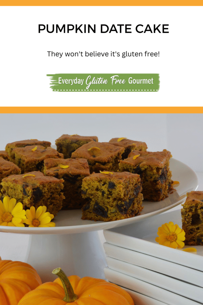 Cut pieces of Pumpkin Date Cake on a pedestal tray garnished with edible flowers and surrounded my mini pumpkins.