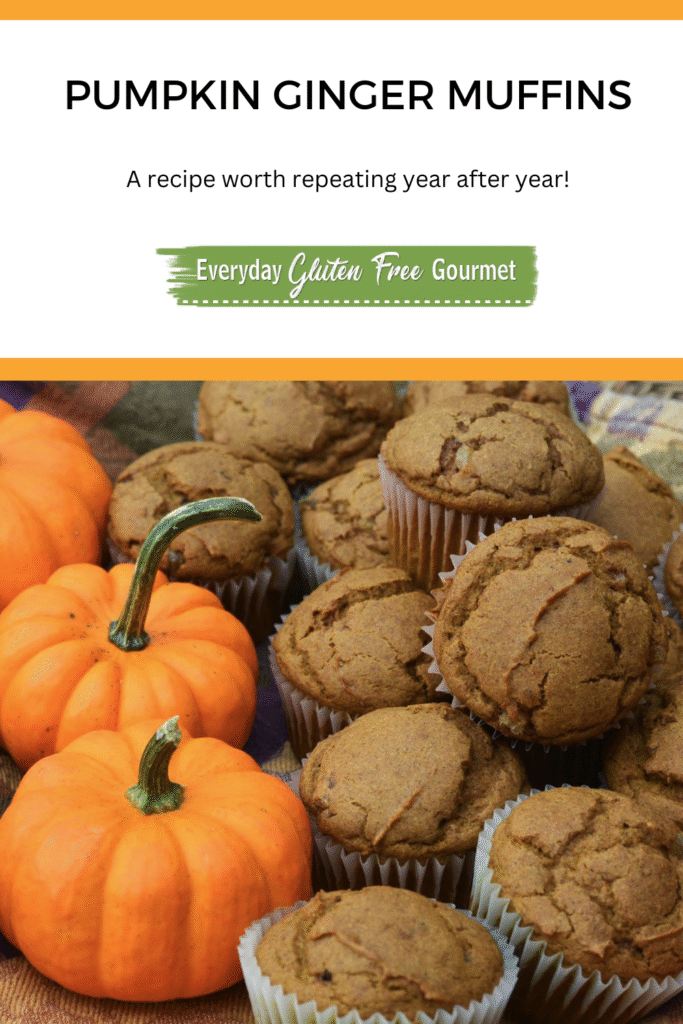 A basket of gluten free Pumpkin Ginger Muffins beside orange mini pumpkins.