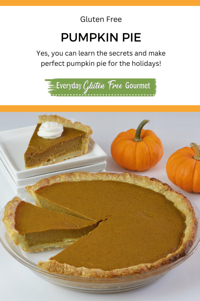 A whole gluten free Pumpkin Pie with one piece placed on a plate and 2 mini pumpkins beside it.