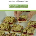 Someone taking a piece from a tray of gluten free Raspberry Crumble Bars.